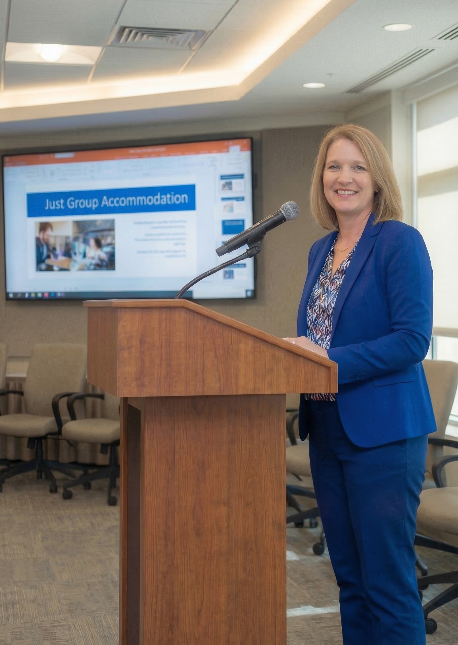A woman standing at a lecturn